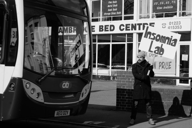 Mehrdad Seyf holding an Insomnia Lab banner outside Cambridge Bed Centre